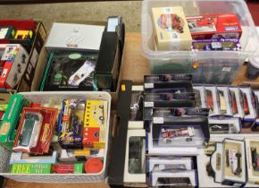 Four boxes containing a large collection of mixed commercial and racing related diecast vehicles, to