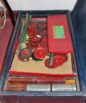 A wooden homemade case containing a quantity of 1950s Meccano