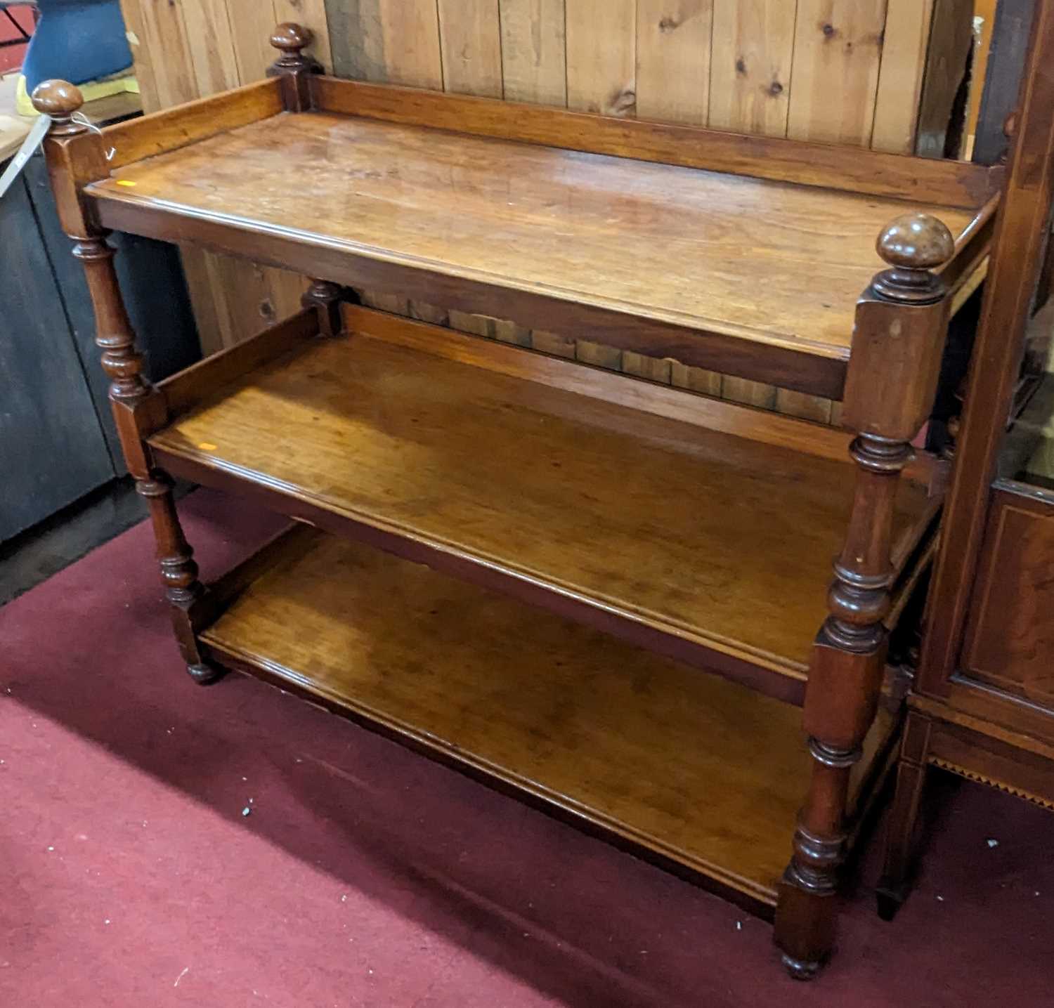 A mid-Victorian mahogany three-tier buffet, raised on turned and square cut supports, w.121cm