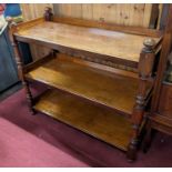 A mid-Victorian mahogany three-tier buffet, raised on turned and square cut supports, w.121cm