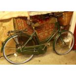 A Pashley green painted lady's bicycle, with Brooks tan leather studded seat, and wicker front