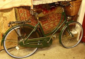 A Pashley green painted lady's bicycle, with Brooks tan leather studded seat, and wicker front