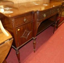 An early 20th century mahogany breakfront sideboard in the Adam taste, having long central frieze