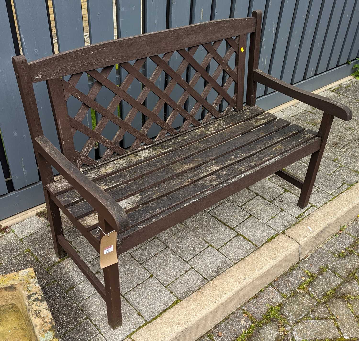 A stained teak slatted two-seater garden bench, width 121.5cm