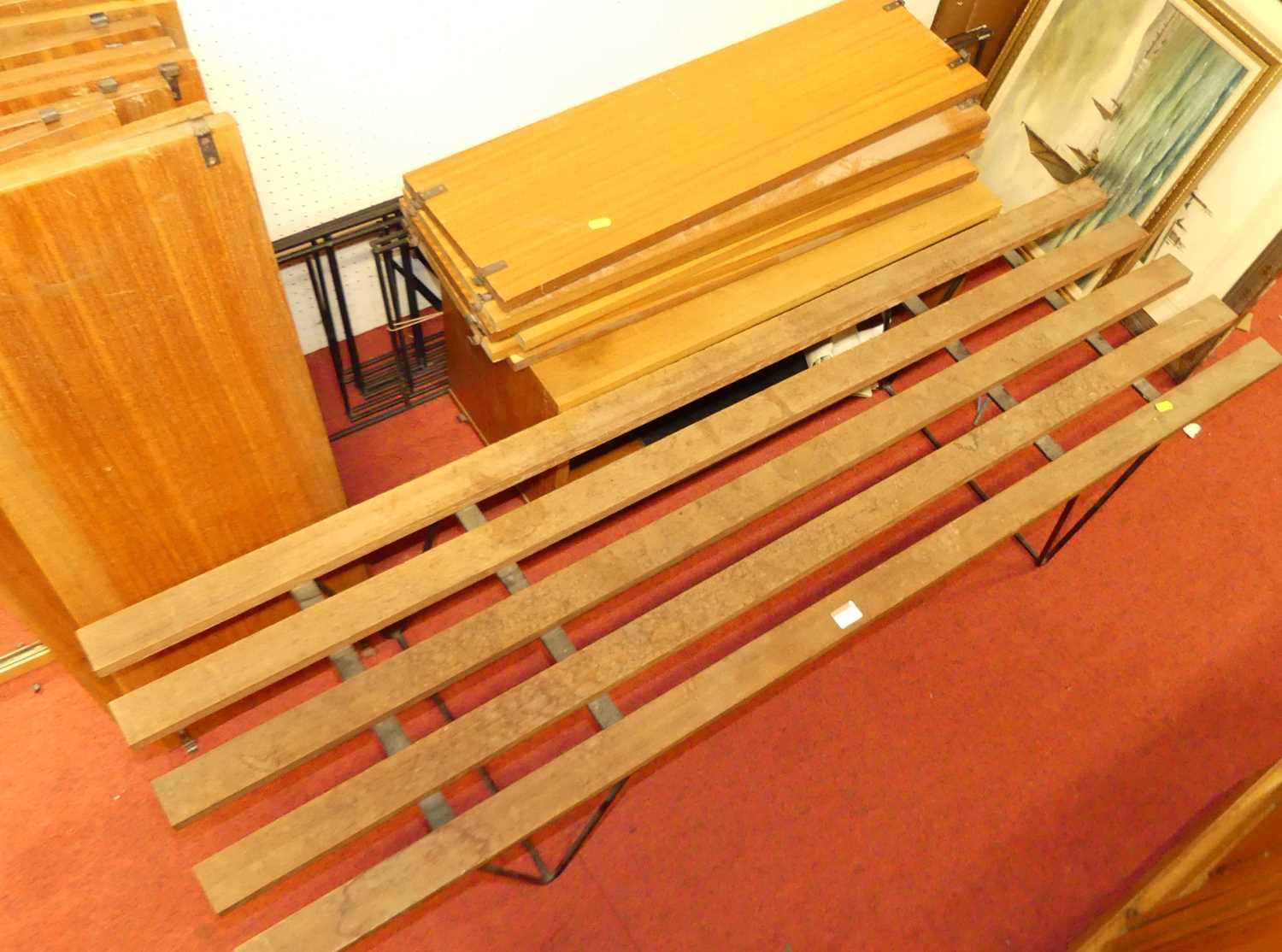 A 1960s black painted wired metal and teak adjustable shelving unit, having five laddered upright