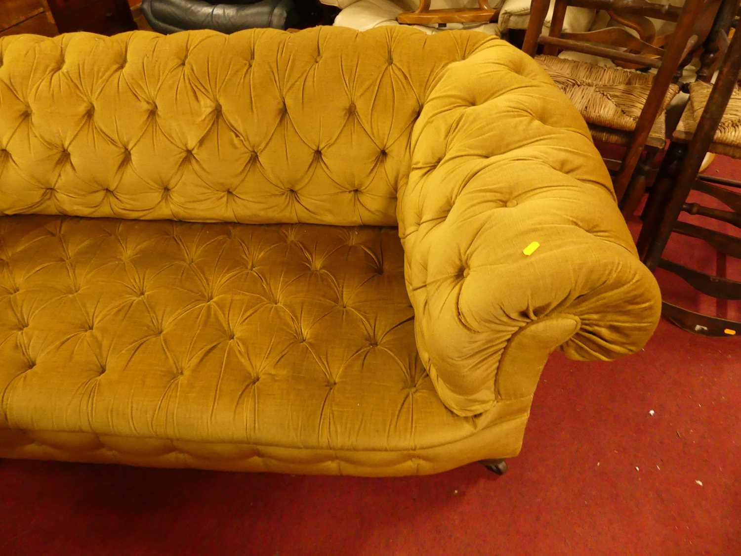 A circa 1900 and later mustard fabric button upholstered two-seater Chesterfield, raised on ring - Image 3 of 4