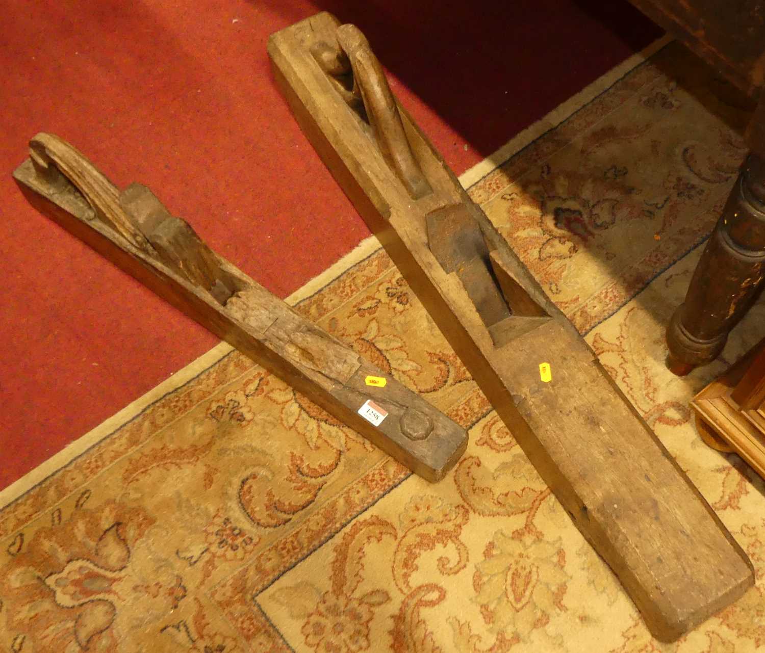 Two rustic long woodworking planes, the larger length 100cm