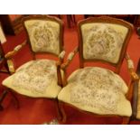 A pair of contemporary French walnut needlework floral and figural upholstered elbow chairs, in