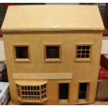 A wooden homemade open front dolls house with a quantity of dolls, fixtures and fittings