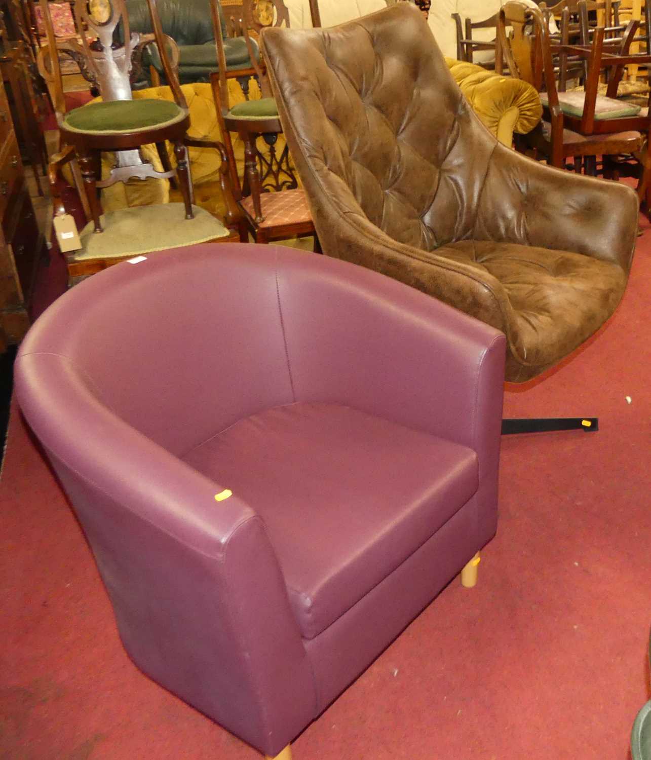 A contemporary soft tan leather upholstered tub swivel armchair, together with a contemporary purple