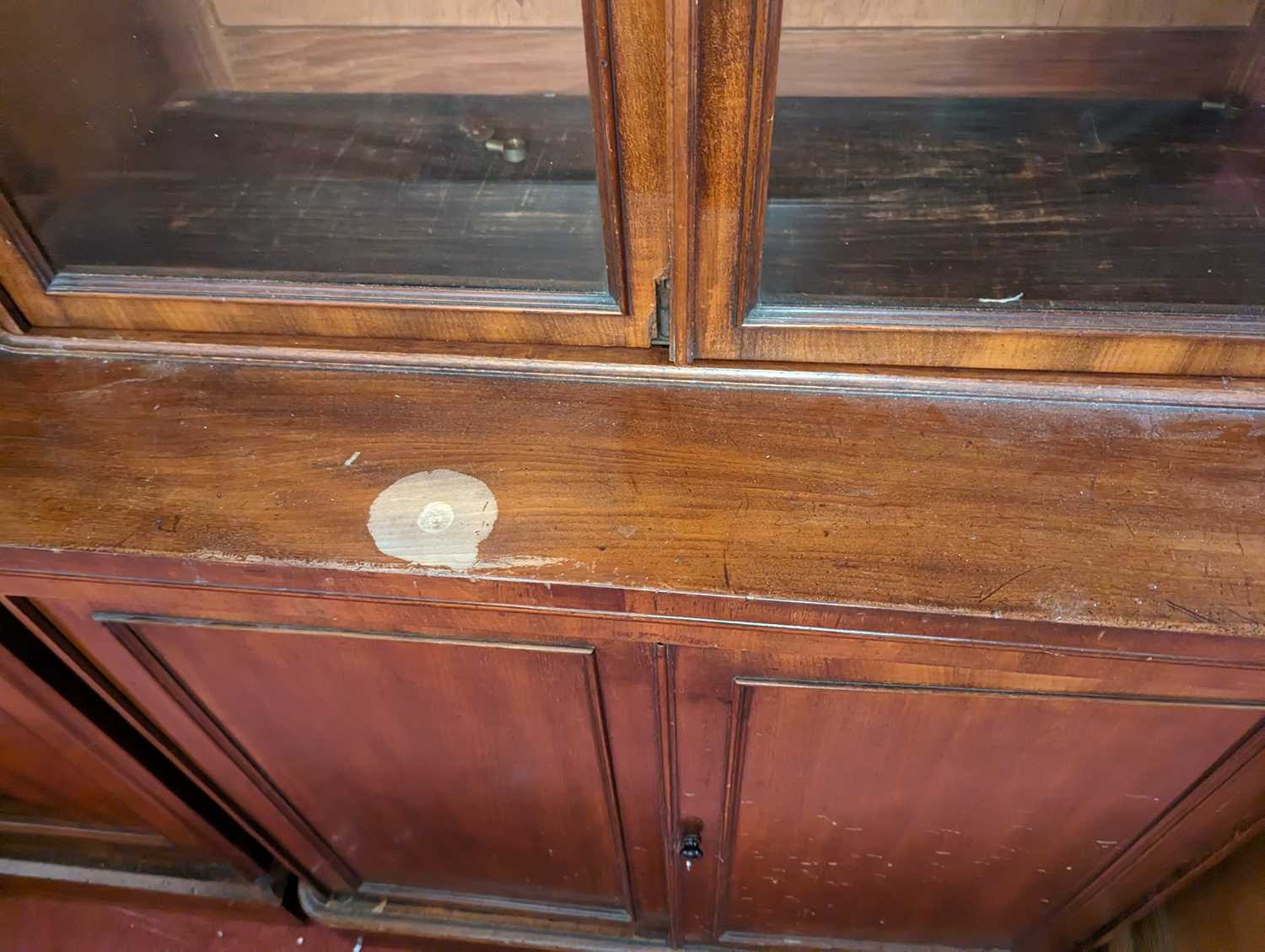 A mid-Victorian narrow mahogany round cornered bookcase cupboard, having twin glazed upper doors - Image 3 of 4