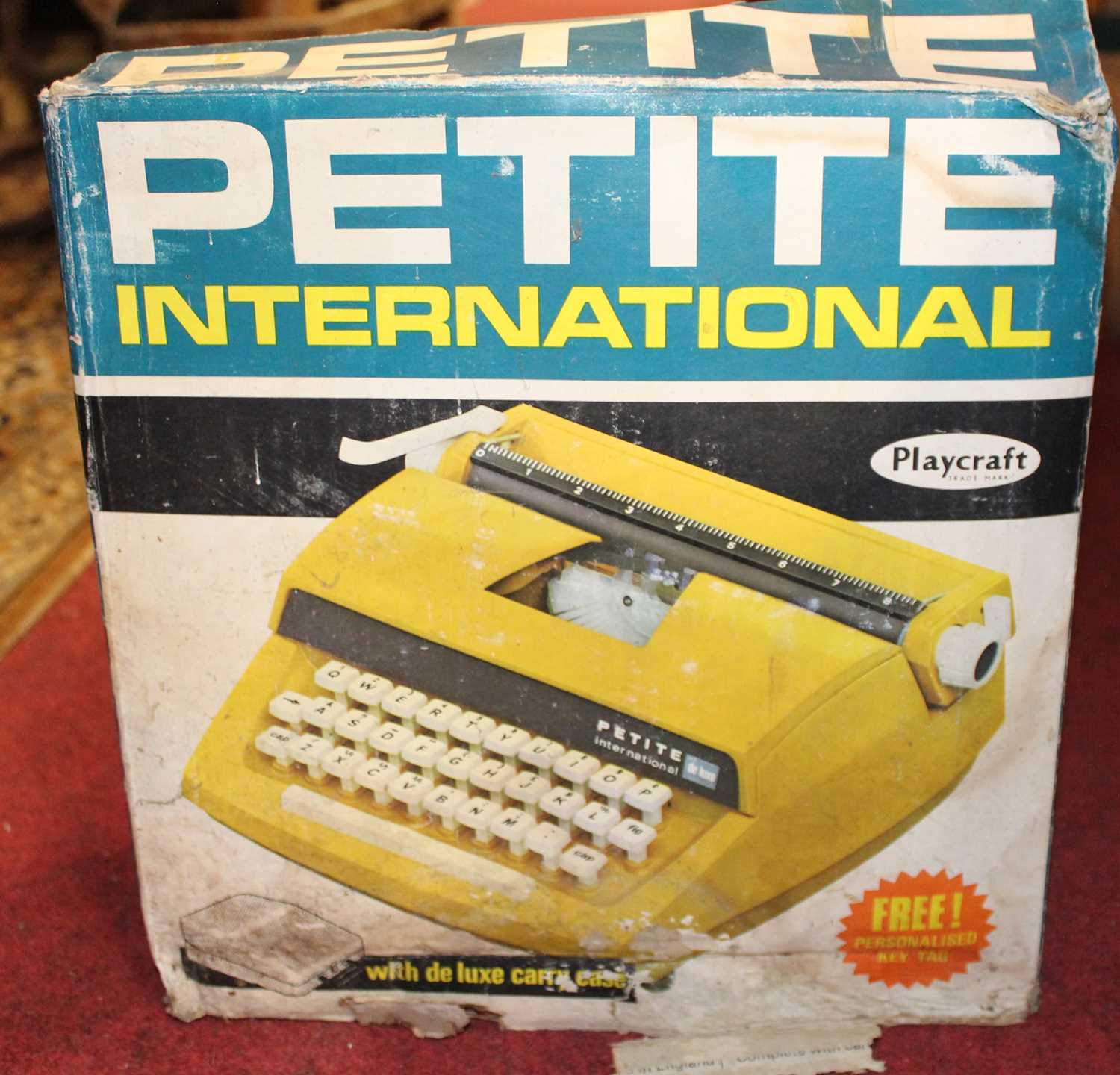 A Playcraft Petite International typewriter housed in the original box