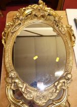 A gilt composition oval wall mirror, 20th century, 64 x 41cm; together with two others (3)