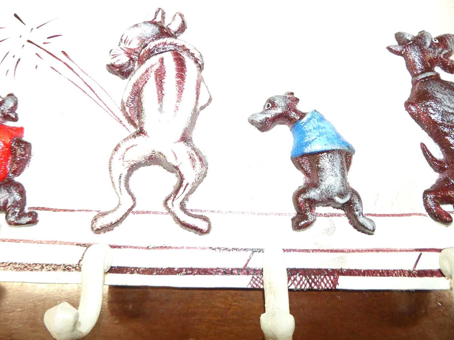 A contemporary painted cast metal wall mounted set of seven hat-hooks, displaying novelty peeing - Image 3 of 4