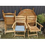 A contemporary slatted teak circular folding garden table, together with a matching set of three