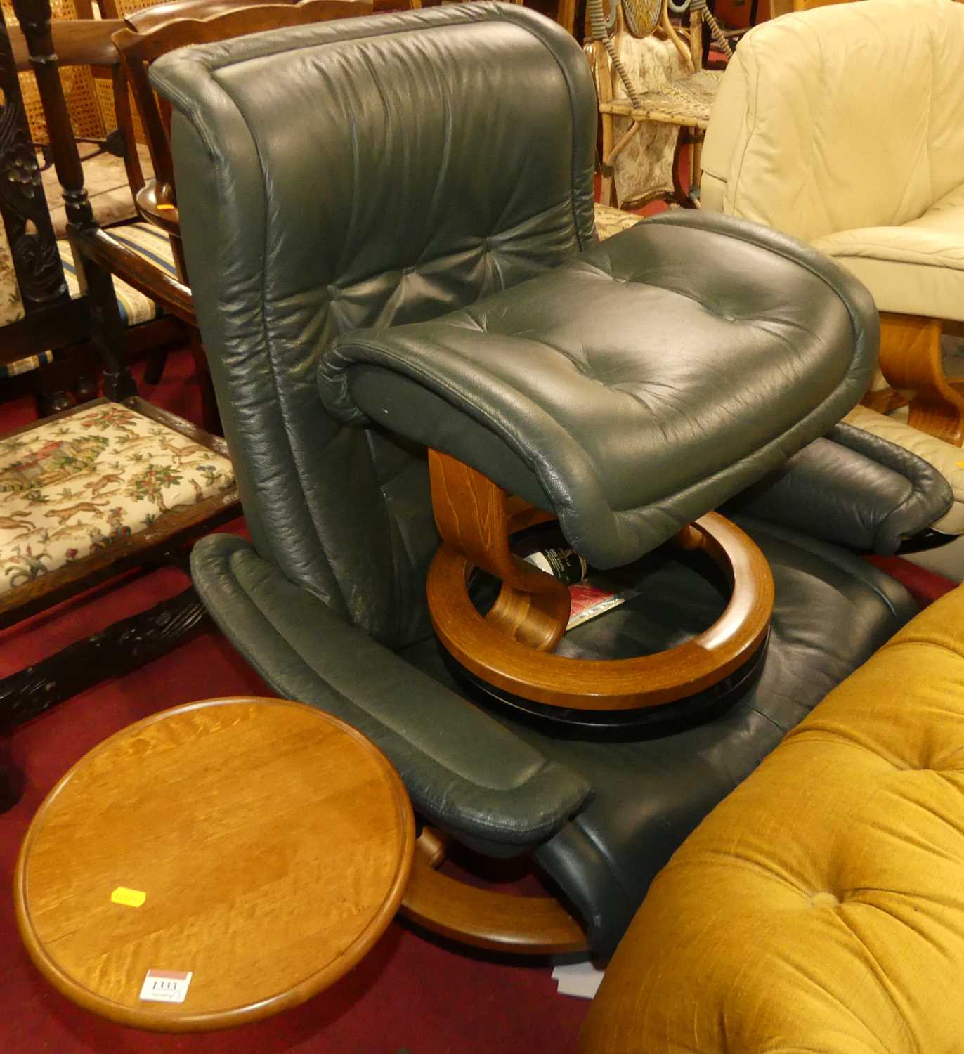 An Ekornes Stressless juniper green leather upholstred swivel reclining armchair, with detachable