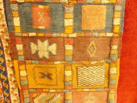 A Turkish woollen red ground rug, having tramline borders and tasselled ends, 250 x 160cm;