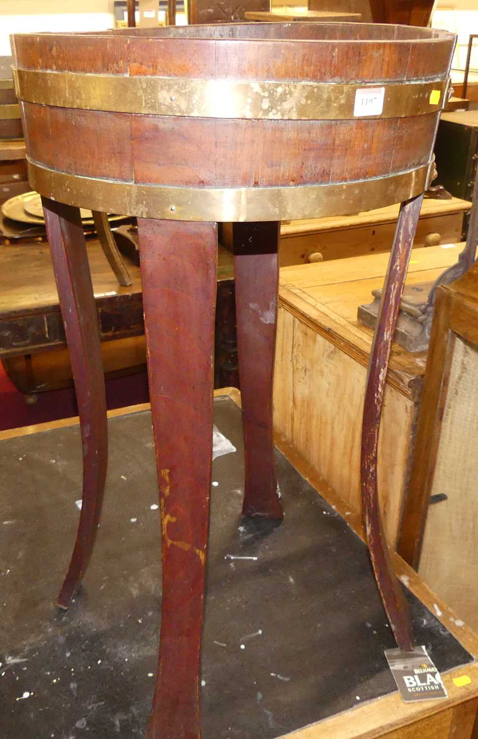 A 19th century mahogany and brass bound circular trough planter, raised on slightly outswept