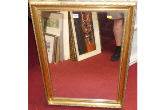 A gilt composition framed and bevelled rectangular wall mirror, 93 x 66cm; together with another - Image 1 of 2