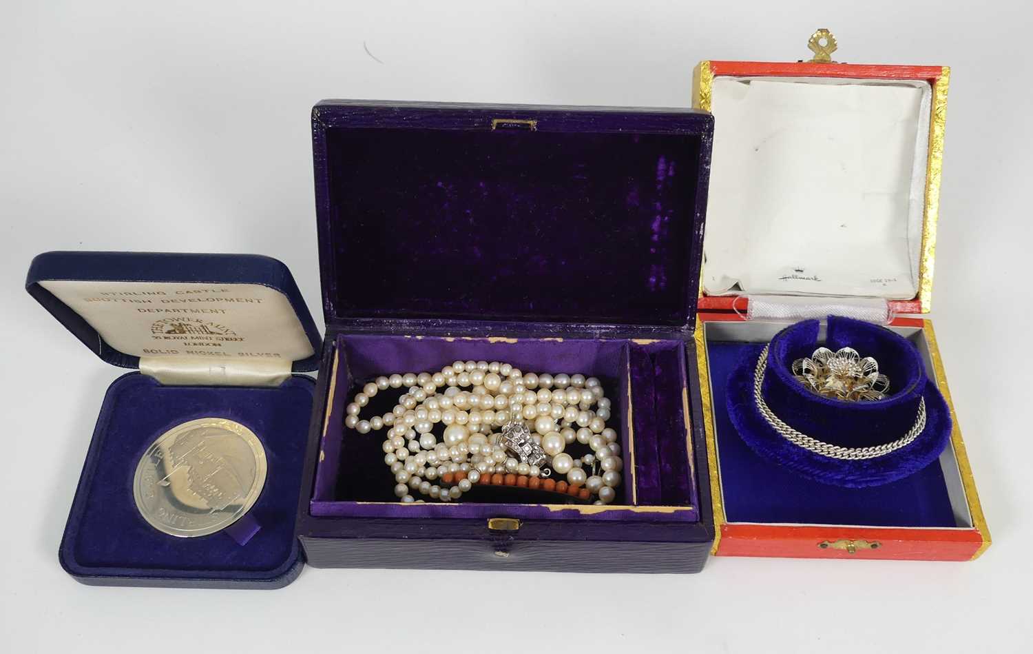 A collection of jewellery to include a floral filigree work pendant, a cultured pearl necklace,