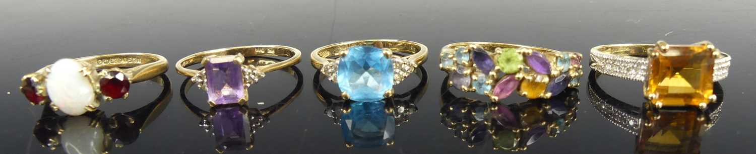 Five various 9ct gold precious and semi-precious set dress rings, to include an emerald cut