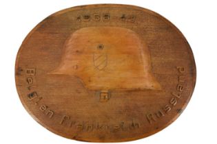 A German Third Reich German prisoner-of-war or similar carved wooden plaque, bearing a well-executed