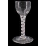 A mid 18th Century opaque twist wine glass, having a fluted rounded bowl, the stem having single