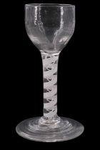 A mid 18th Century opaque twist wine glass, having a fluted rounded bowl, the stem having single