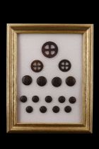 A framed display of Fist Aid Nursing Yeomanry / FANY badges and buttons