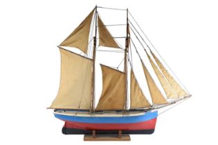 An early-to-mid 20th Century model gaff-rigged schooner (pond yacht), the hull being of painted