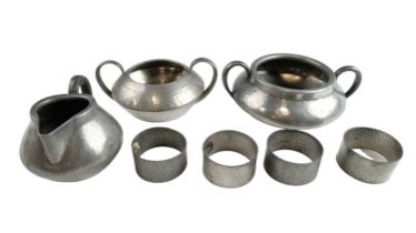 Three items of Tudric pewter, comprising two sugar basins and a cream jug, together with four