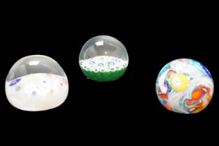 A millefiori glass paperweight together with two other weights