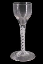 A mid 18th Century opaque twist wine glass, having and ogee bowl and multiple spiral opaque twist