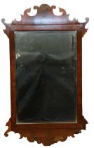 An old reproduction mahogany Chippendale style fret mirror, bearing label verso "Reproduction mirror