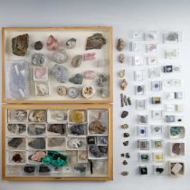 A collection of rock and mineral specimens, many labelled with find locations, including crystals,