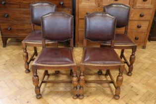 A set of four 1930s leather upholstered oak dining chairs, 87 cm