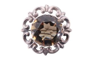 A Scottish citrine and silver brooch by Thomas Kerr Ebbutt, comprising a 20 mm citrine claw set over