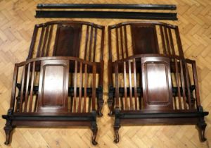 A pair of George V mahogany single beds retailed by Harrods of London, bearing retailer's ivorine