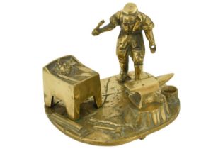 A mid-to-late 20th Century cast brass figure of a blacksmith at his forge