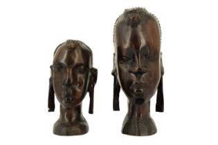 A pair of African carved hardwood busts of two tribeswomen, 20th Century, 21 cm tallest Qty: 2