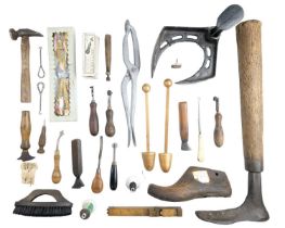 Vintage cobbler's lasts and a quantity of related tools, including a brass and boxwood foot