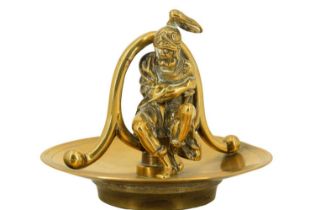 A figural cast brass mantle ornament modelled as a seated seated Roman / Greek soldier, 10 cm