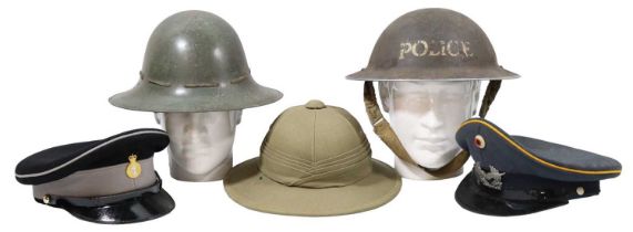 Sundry items of military headgear including a Second World War Police helmet shell, a Fire Watcher's