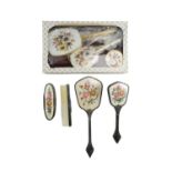 A boxed gilt-metal mounted dressing table set together with an open-work metal mounted brush set,