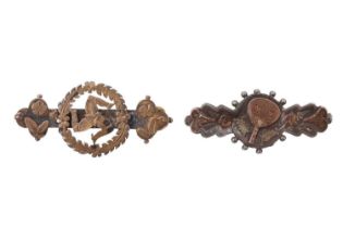 Two Victorian gilt-faced silver brooches, one decorated with triskelion, the other a ping-pong bat