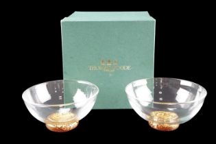 A boxed pair of Thomas Goode free-blown glass bowls, each having a parcel-gilt red glass foot,