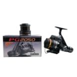 A Daiwa PG2050 spinning fishing reel with two spools