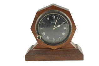 A walnut mounted dashboard clock, having a 1930s - 1940s clock fitted into a handmade stand, the