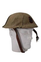 A toy British army "Brodie" steel helmet having a canvas cover and Royal Army Medical Corps badge