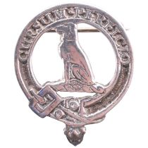 A Scottish white metal badge for clan Hunter, having a crest of a hound, gorged with an antique